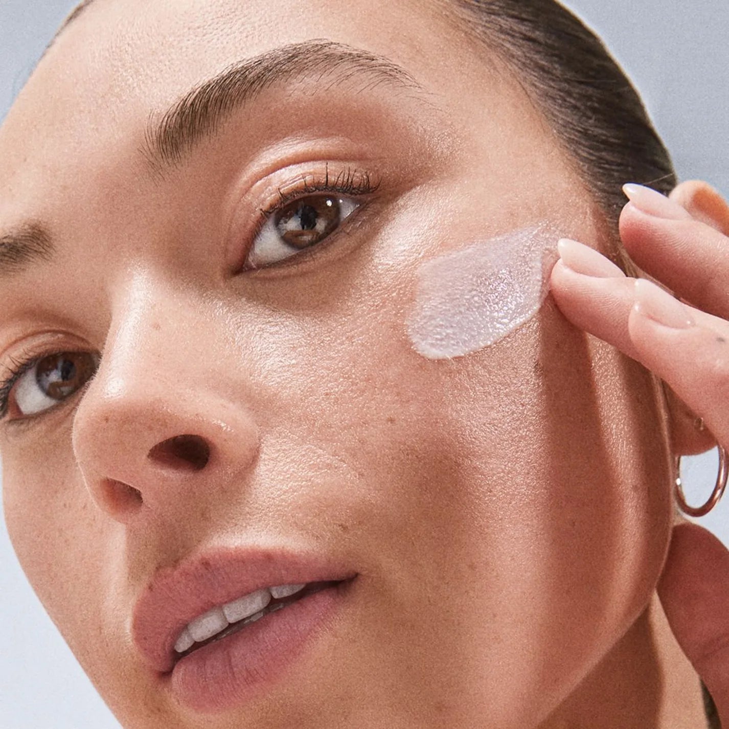 Model applying Dermalogica dynamic skin recovery 100ml (jumbo size) product closeup